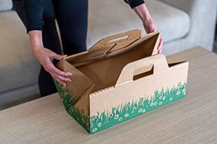 Hands folding and locking the Ten Second Litter Box closed